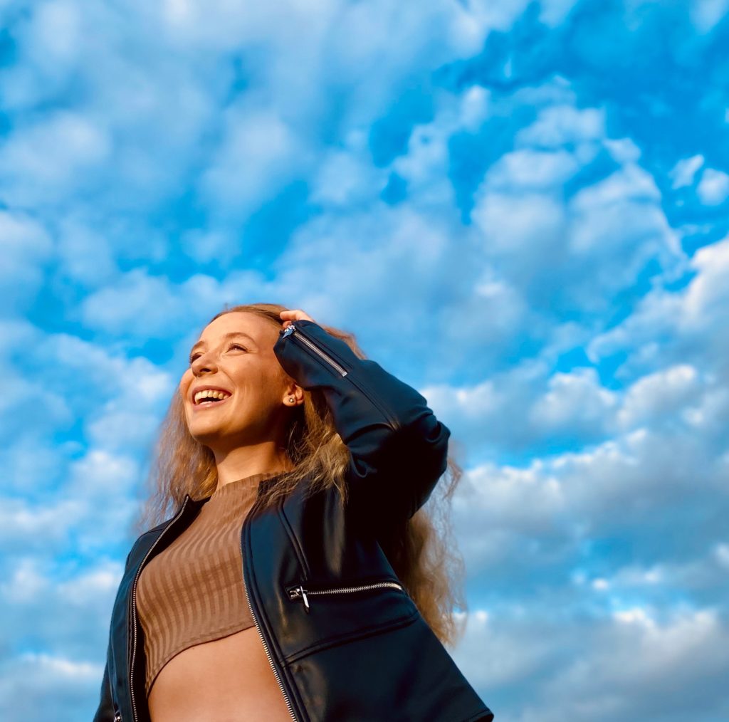 Pia-mingenbach-professional-career-marketing-commitment-hobby-passion-interests-picture-smiling-blue-sky-perspective-leather-jacket